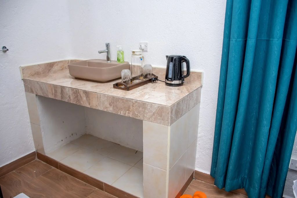 In-room marble wash counter with kettle and glassware tray