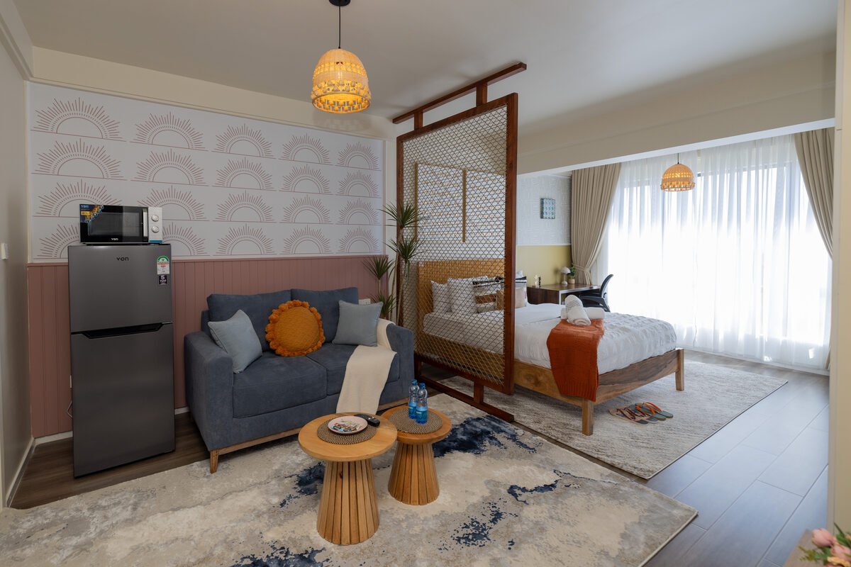 Woven rattan room divider separating the bedroom from the living area