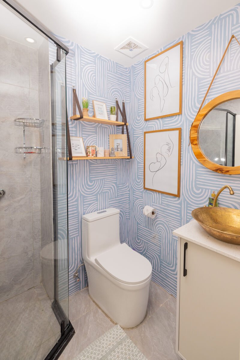 Renovated Kilimani studio bathroom with glass shower enclosure and gold vessel sink