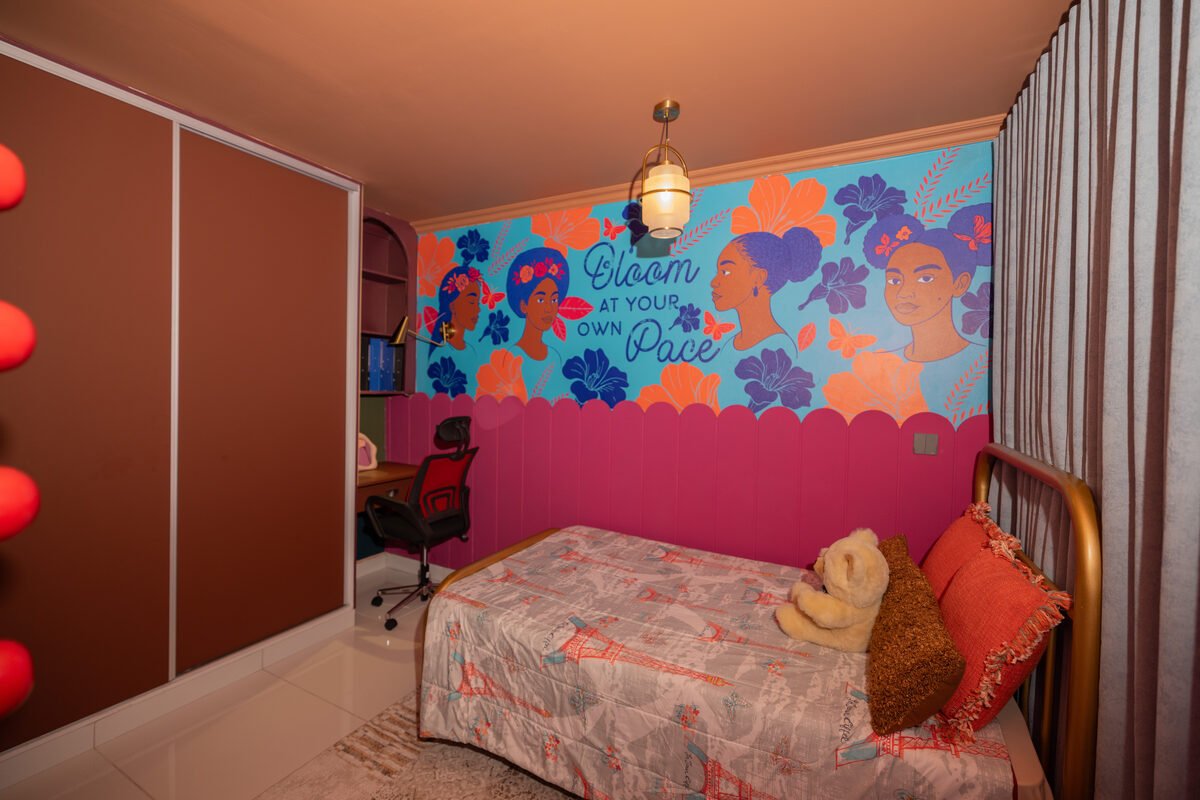 Bedroom view showing brown sliding wardrobe doors with a red accent lighting strip and desk nook