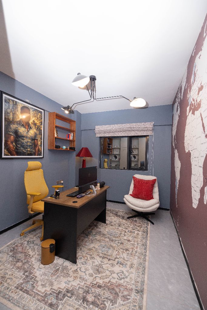 Home office with world map feature wall and cream cabinetry, Nairobi family residence